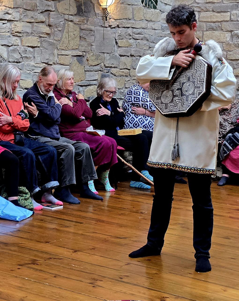 Pablo Teiwaz playing a shamanic drum in a ceremonial setting.
