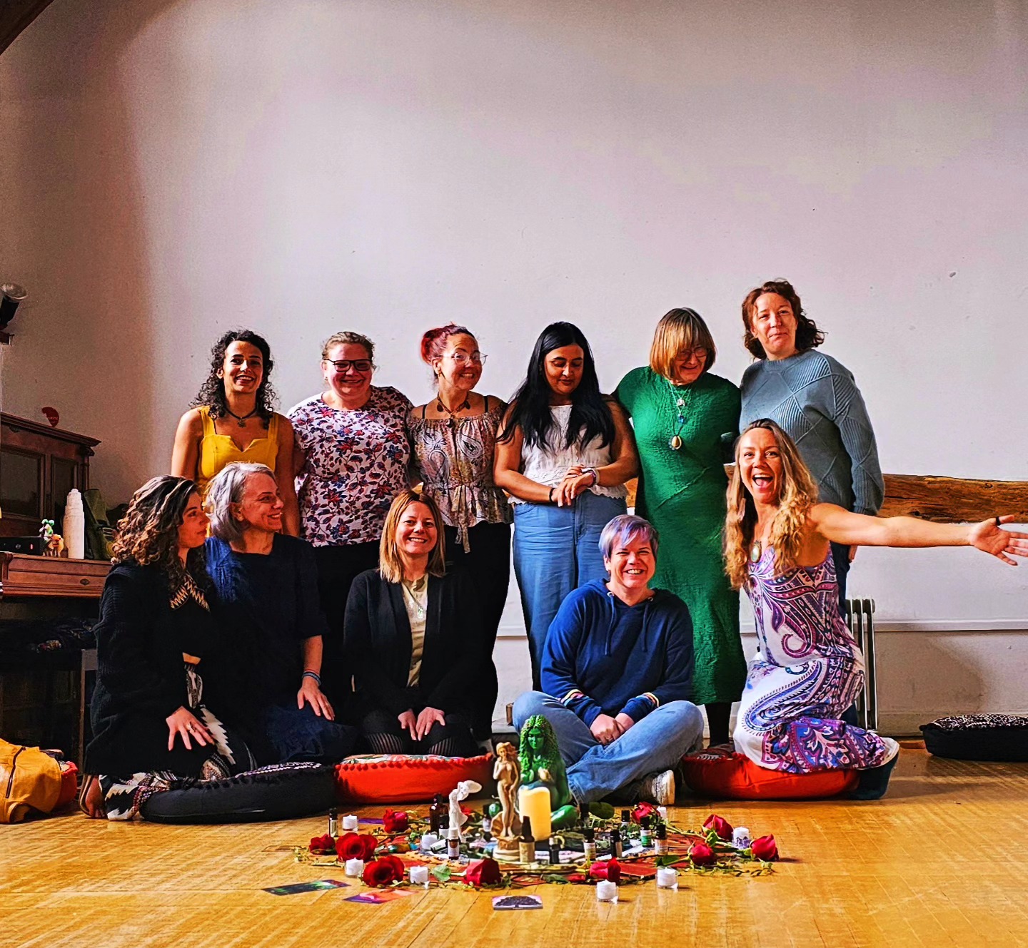 A women's circle with candles and sacred objects.